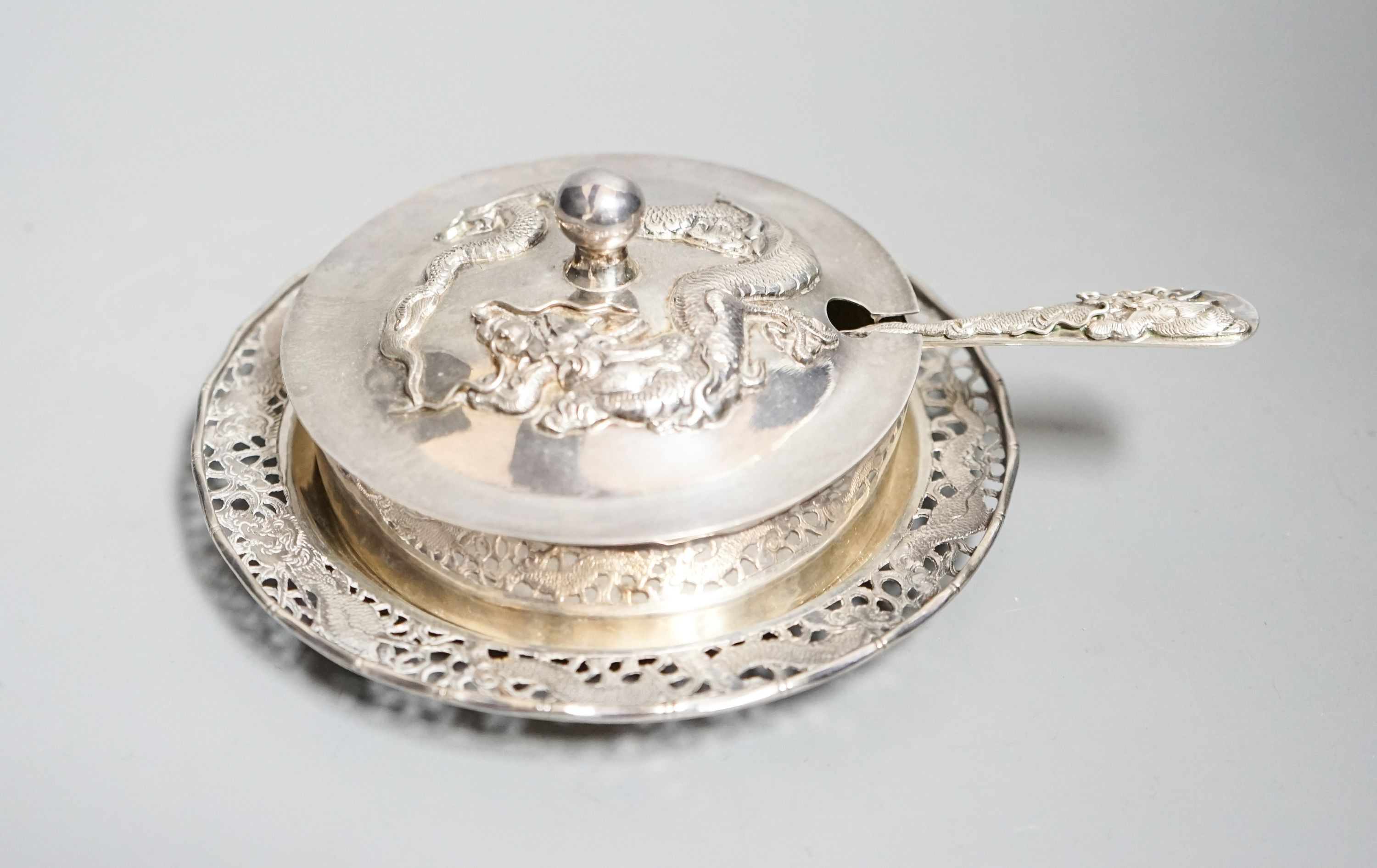 A Chinese white metal butter dish, on stand with knife by Tack Hing, with glass liner, 14.2cm.